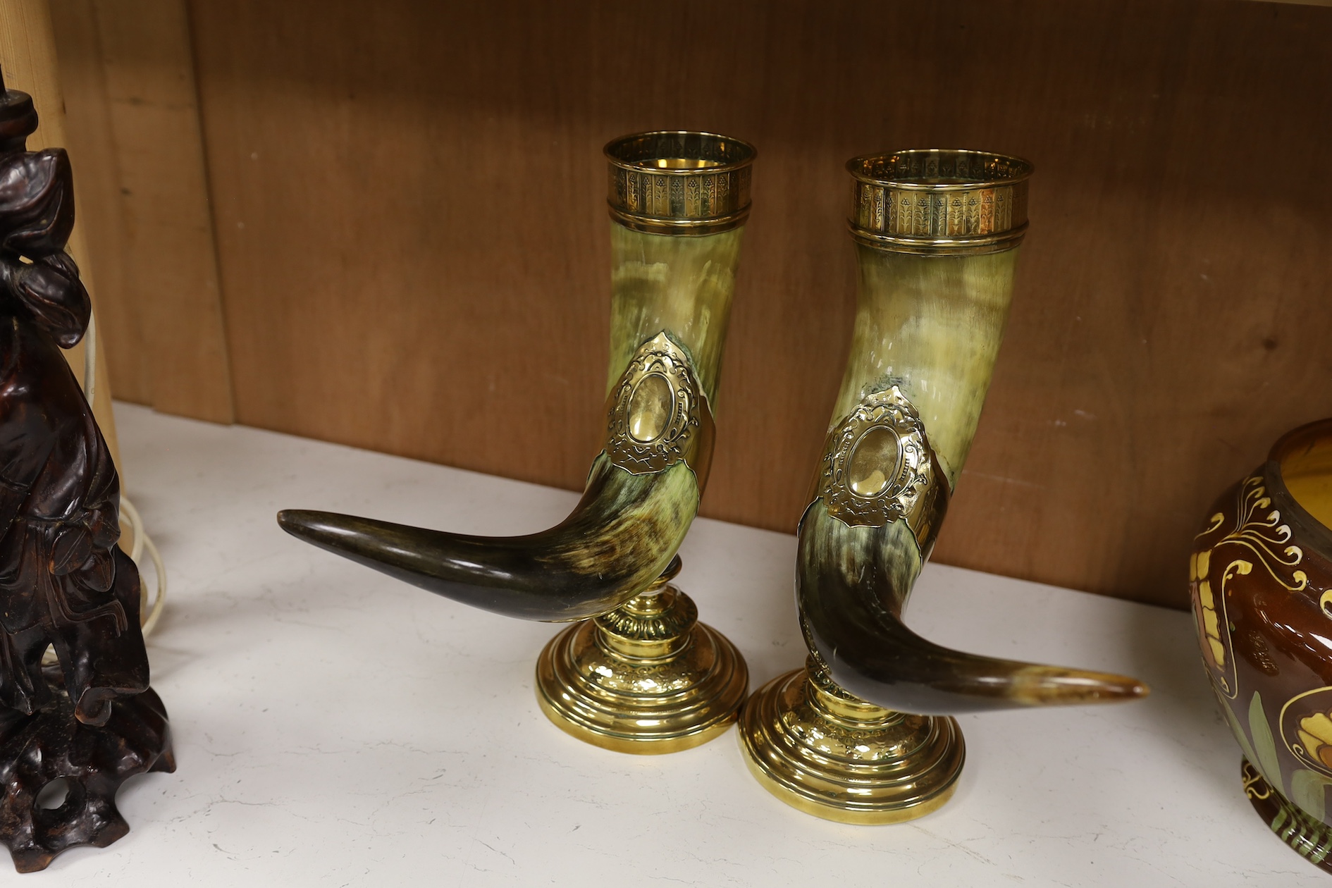 A pair of large decorative brass mounted horns, 33cm high. Condition - brass mounts dented and horns scratched in places